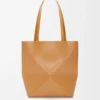 0a9a7646fa4f1e6e53fba62e0b9a6ea1-scaled-1.webp Medium Puzzle Fold tote in shiny calfskin