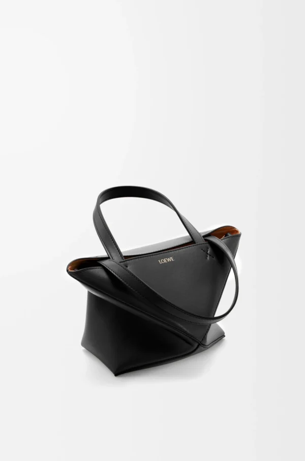 0b176d29ba49855554419e37dfb23cab-scaled-1.webp Mini Puzzle Fold tote in shiny calfskin