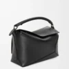 73344ad9eb30cf1dd359fb8796bc2499-scaled-1.webp Puzzle bag in classic calfskin