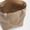 7724596c80277d1c029413ea685fc792-scaled-1.webp Mini Puzzle Fold tote in shiny calfskin