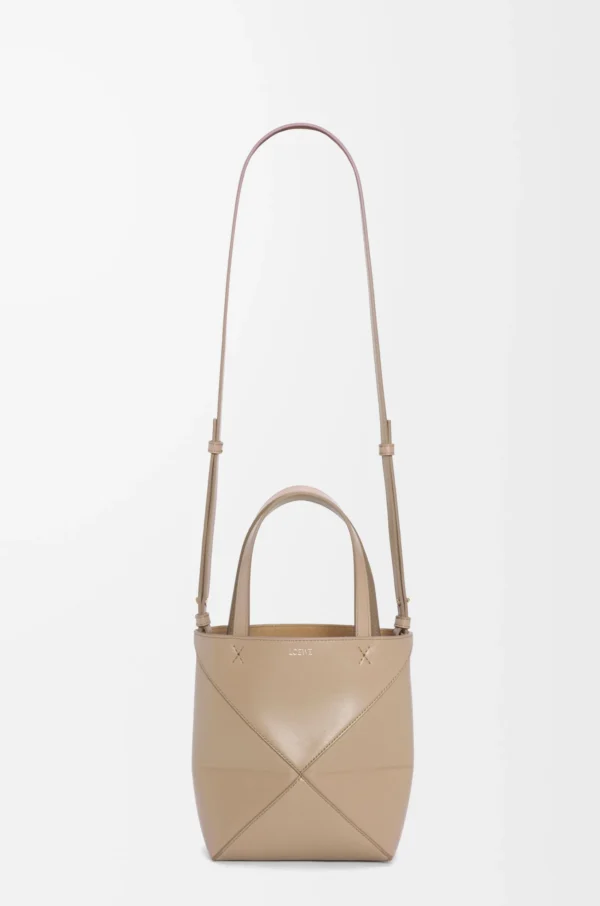7a714e6268eee9f876ff6dd27779129b-scaled-1.webp Mini Puzzle Fold tote in shiny calfskin