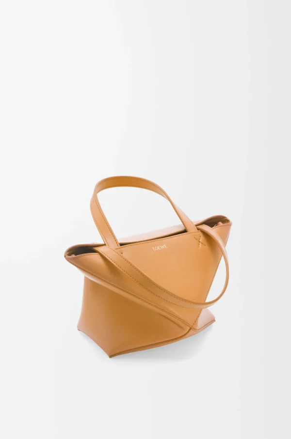 7d954bf0940eb954f262e9097da59817-scaled-1.webp Mini Puzzle Fold tote in shiny calfskin