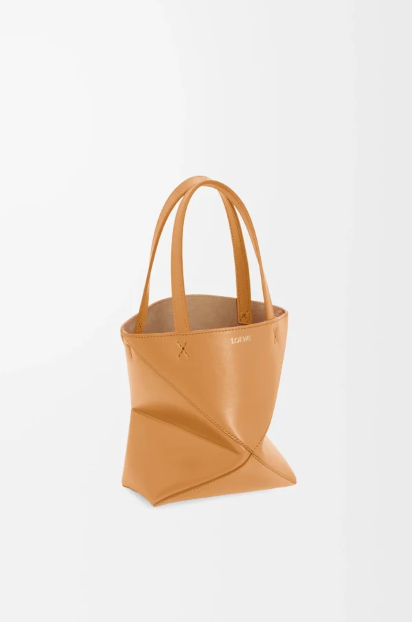 8f9b9024335181e653665ef242ae3719-scaled-1.webp Mini Puzzle Fold tote in shiny calfskin