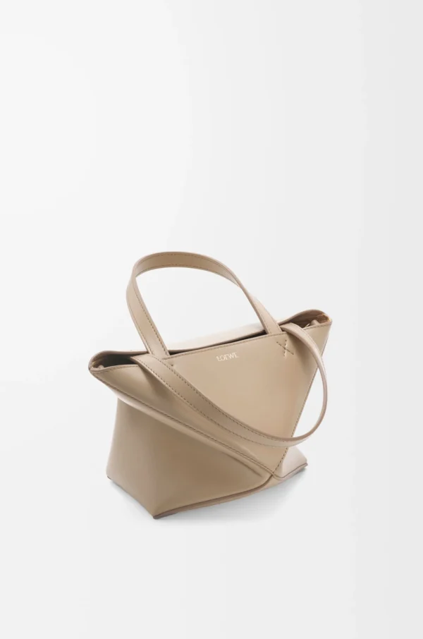 a0f445a79fc22ff78e22ca86a0600cf0-scaled-1.webp Mini Puzzle Fold tote in shiny calfskin