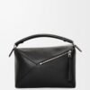 a500ee8257d5538f6fa7fb42029544c8.jpg Puzzle bag in classic calfskin