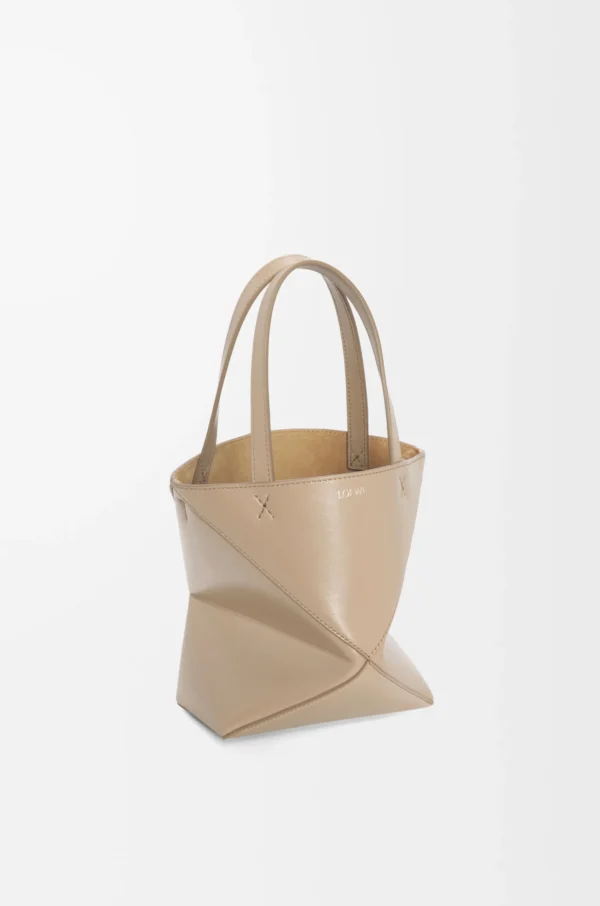 b8abee123f715ec727157cd49f2bbe2f-scaled-1.webp Mini Puzzle Fold tote in shiny calfskin